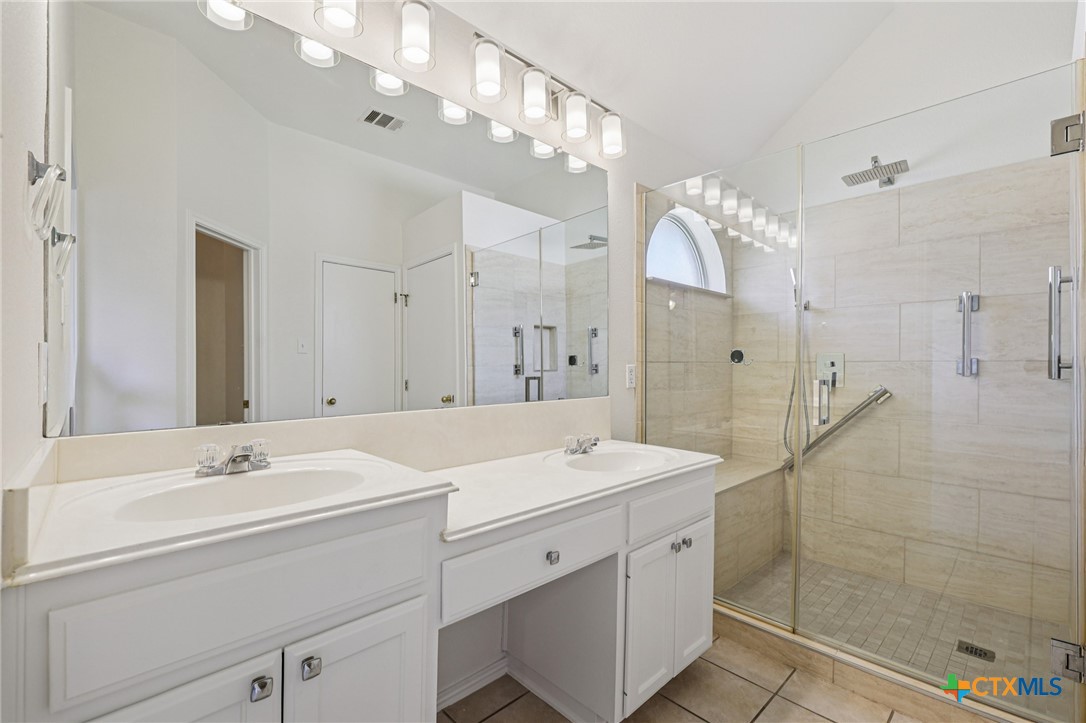 303 North Kings Canyon Drive Cedar Park, TX 78613 - Photo 9 of 24 a spacious bathroom with a shower sink mirror and double