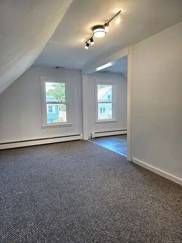 an empty room with windows and closet