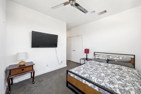 a bedroom with a bed and a flat screen tv