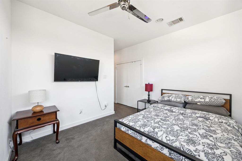 4903 Jack Court Dallas, TX 75206 - Photo 11 of 26 a bedroom with a bed and a flat screen tv