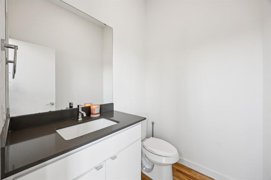 4903 Jack Court Dallas, TX 75206 - Photo 12 of 26 a bathroom with a granite countertop sink and a toilet