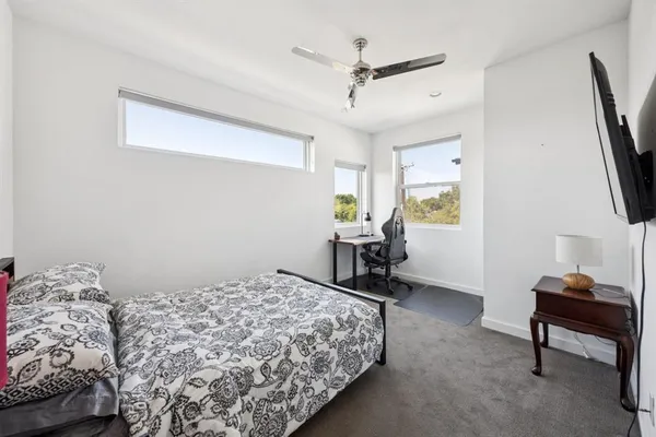 a bedroom with bed and a window