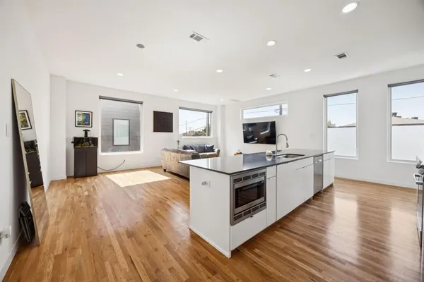 a view of kitchen with microwave a stove and refrigerator