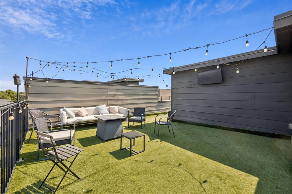 4903 Jack Court Dallas, TX 75206 - Photo 25 of 26 a view of patio with table and chairs with wooden floor