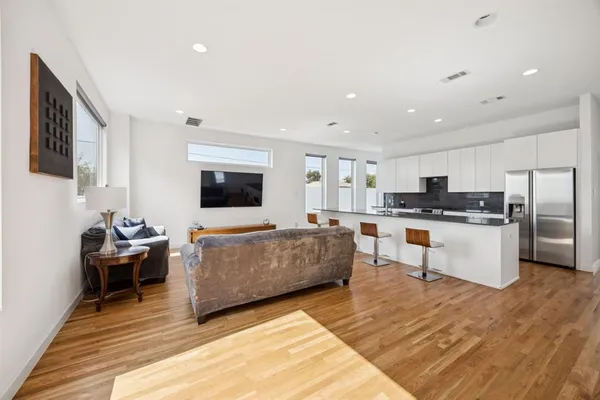 a living room with furniture and kitchen view