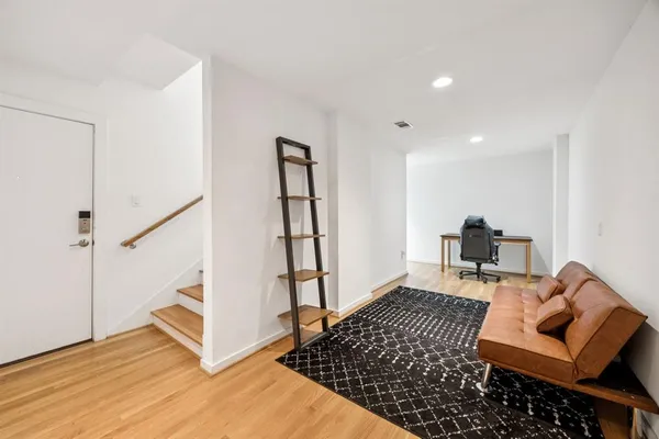 a living room with furniture and a rug