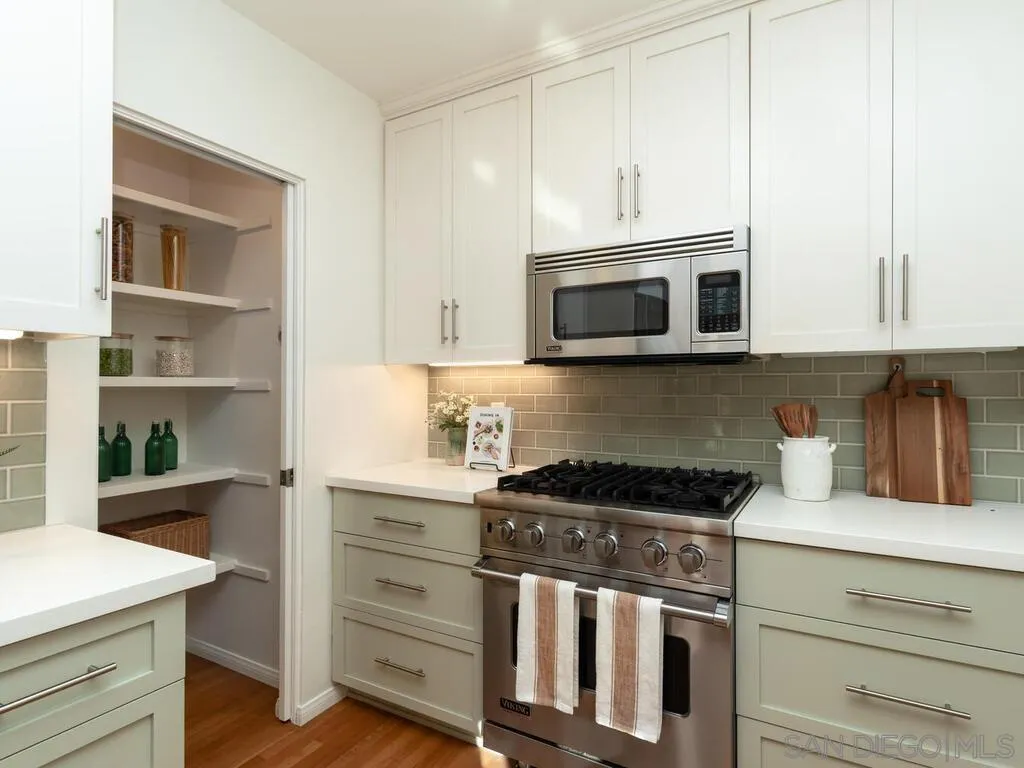 4611 Natalie Drive San Diego, CA 92115 - Photo 18 of 41 a kitchen with granite countertop cabinets stainless steel appliances and wooden floor