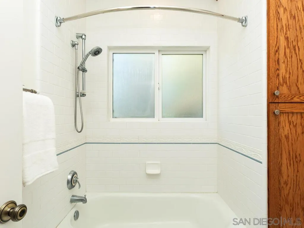 4611 Natalie Drive San Diego, CA 92115 - Photo 28 of 41 a bathroom with a bathtub and a shower
