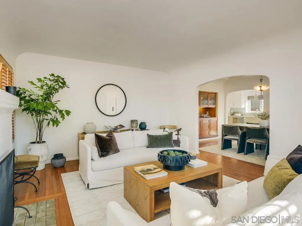 4611 Natalie Drive San Diego, CA 92115 - Photo 8 of 41 a living room with furniture a chandelier and a fireplace