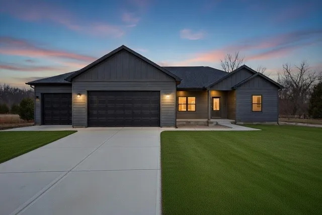 a front view of house with yard and green space