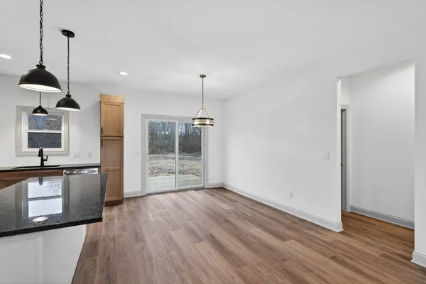 a kitchen with stainless steel appliances a refrigerator and a wooden floor
