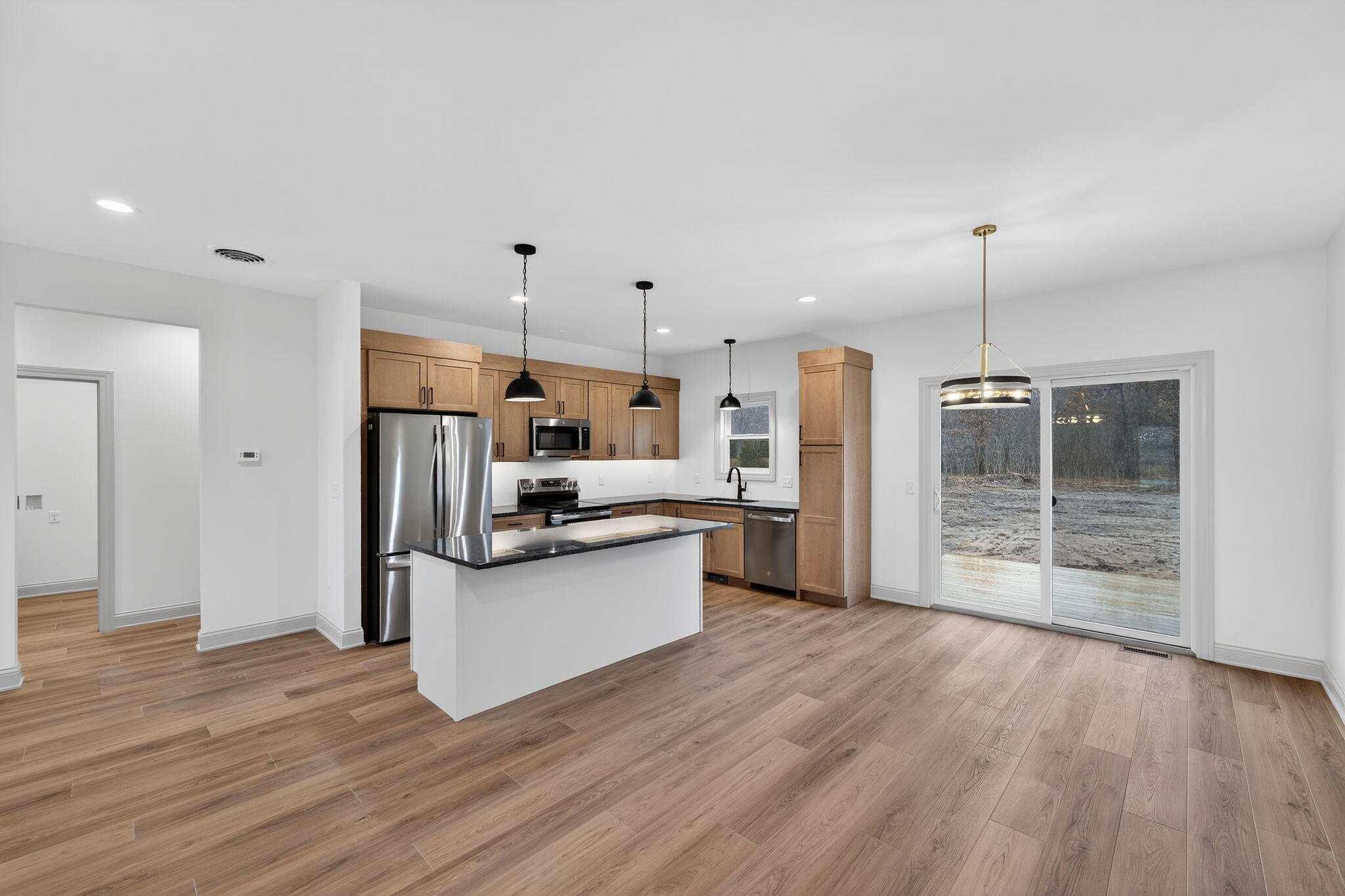238 East 550 North Rensselaer, IN 47978 - Photo 13 of 35 a kitchen with stainless steel appliances a refrigerator and a wooden floor