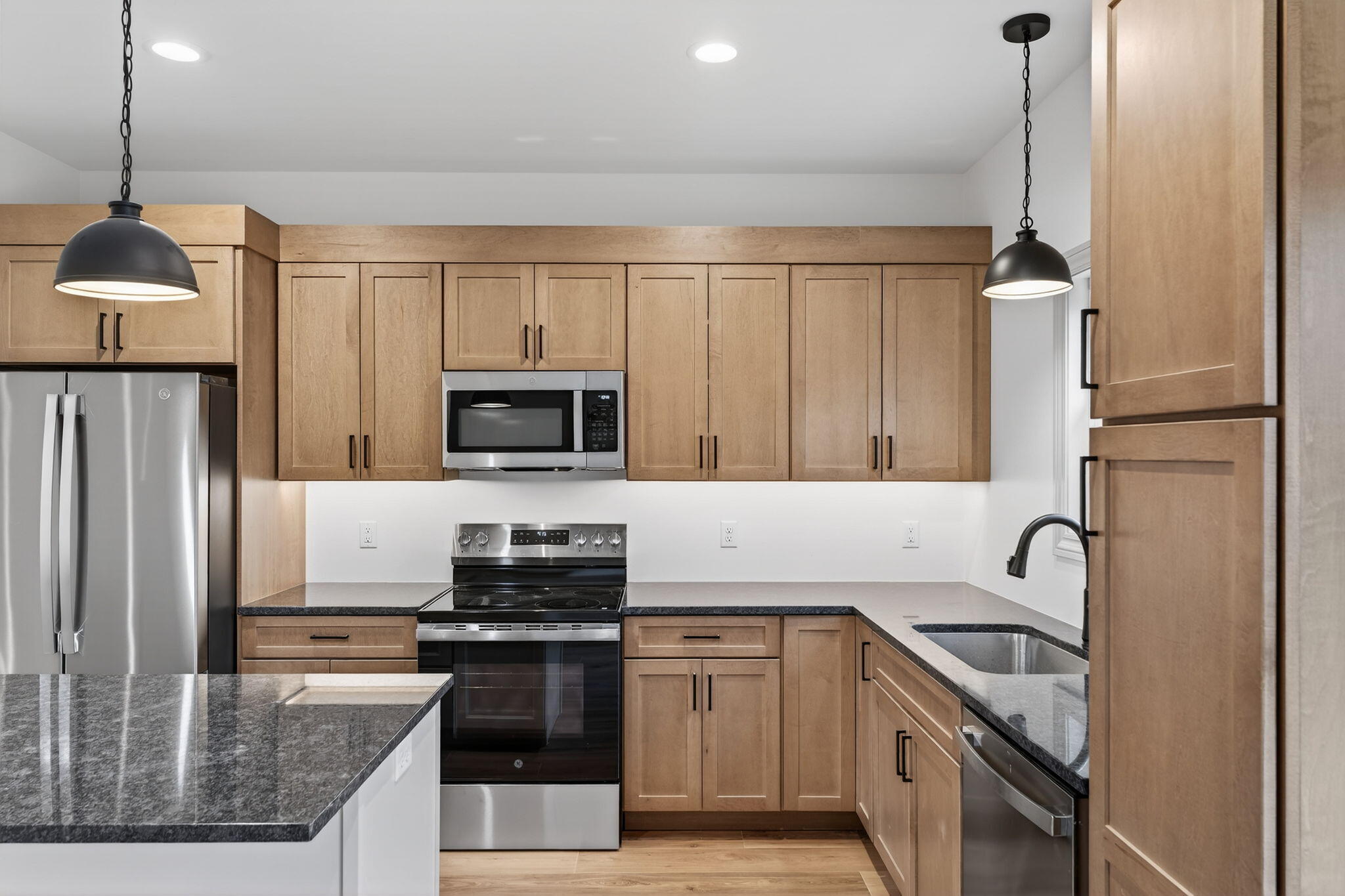 238 East 550 North Rensselaer, IN 47978 - Photo 16 of 35 a kitchen with stainless steel appliances granite countertop a sink a stove and a refrigerator