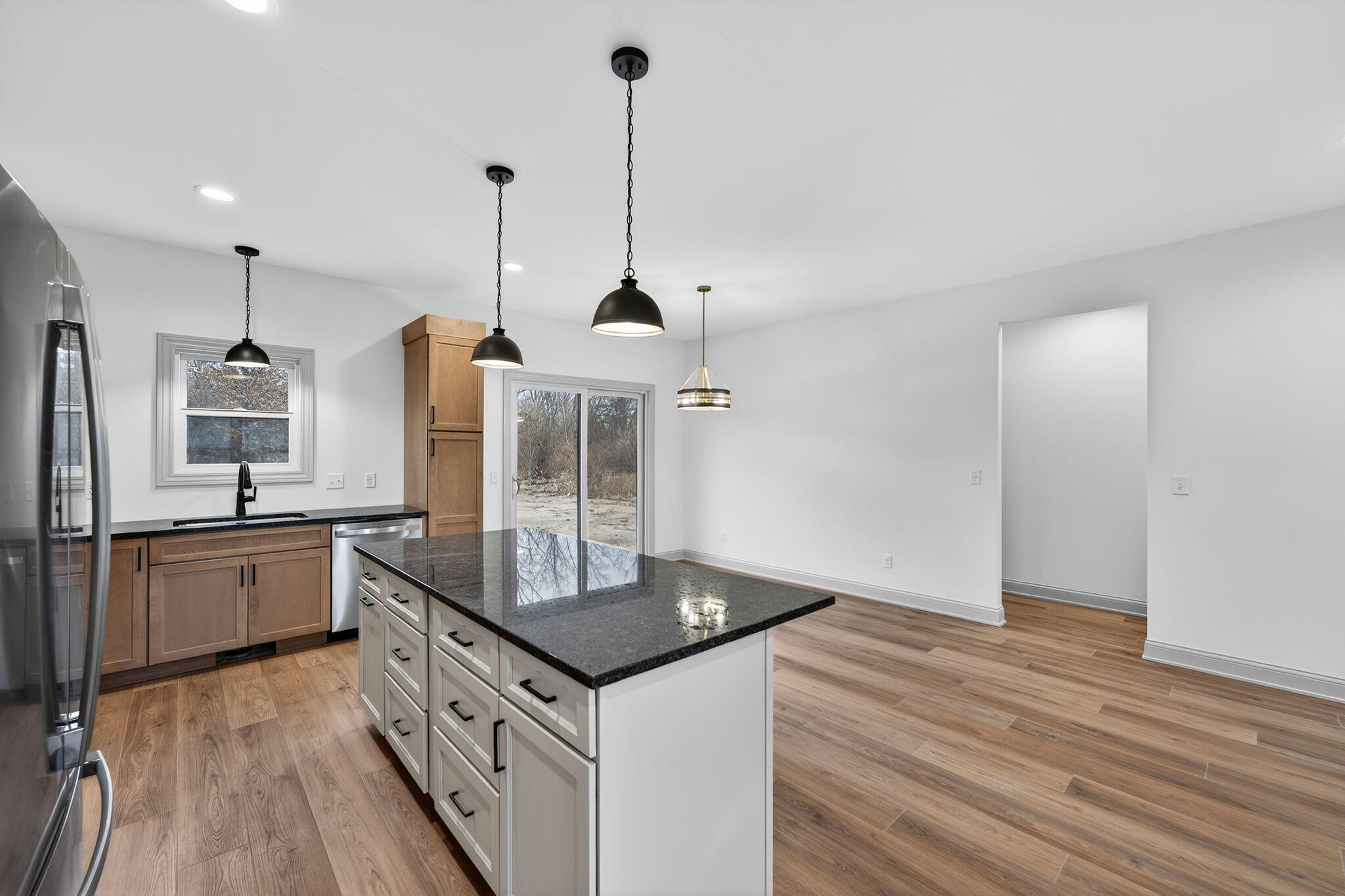 238 East 550 North Rensselaer, IN 47978 - Photo 16 of 33 a kitchen with stainless steel appliances granite countertop a sink a stove and a wooden floors