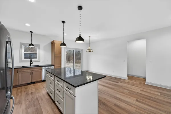 a kitchen with a sink stove and refrigerator