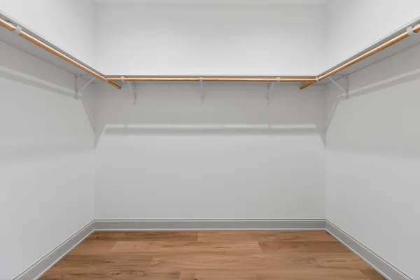 a bedroom with a bed and a potted plant