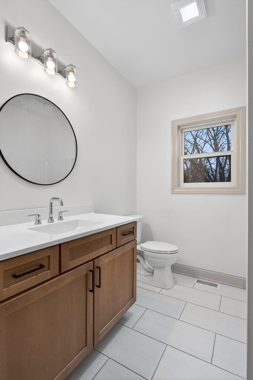238 East 550 North Rensselaer, IN 47978 - Photo 29 of 33 a bathroom with a toilet a sink and mirror