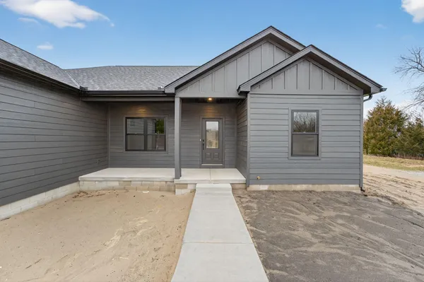 a view of a kitchen with wooden floor and a sink