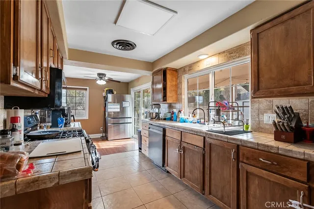 a kitchen with stainless steel appliances granite countertop a sink and cabinets