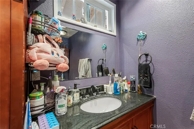 a bathroom with a sink a vanity and a mirror