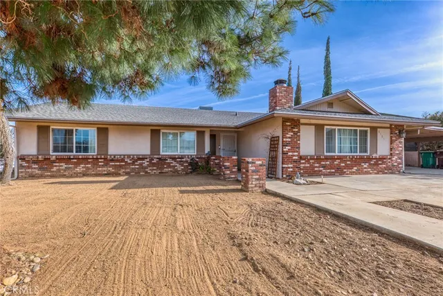 a front view of a house with yard patio and outdoor seating