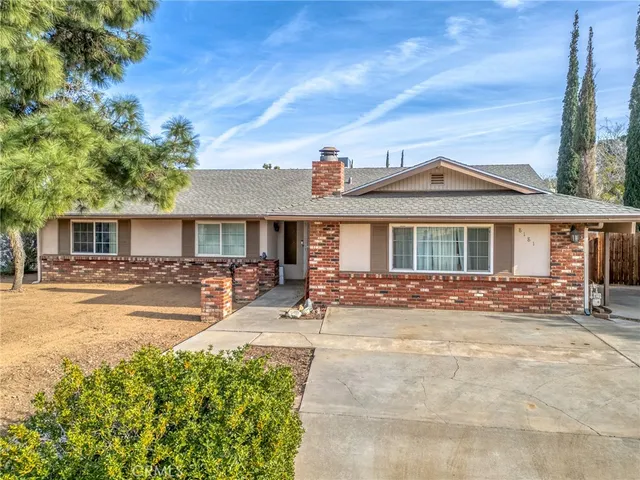 a front view of a house with yard patio and fire pit
