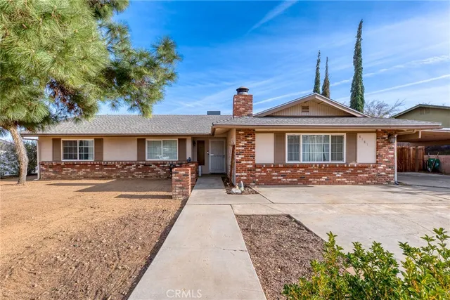a front view of a house with yard patio and swimming pool