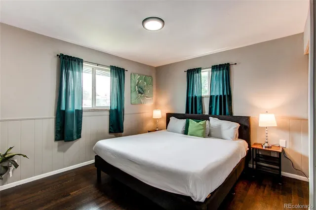 a bedroom with a bed and a night stand