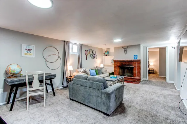 a living room with furniture and a fireplace