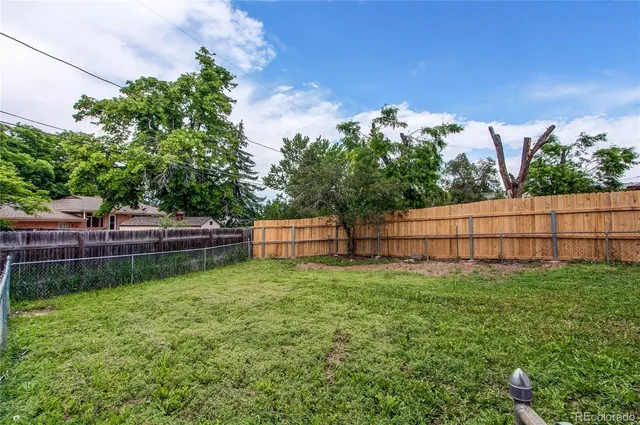 a backyard of a house with table and chairs