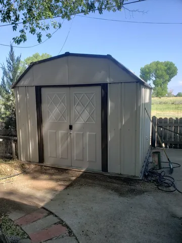 an aerial view of residential houses with outdoor space and lake view