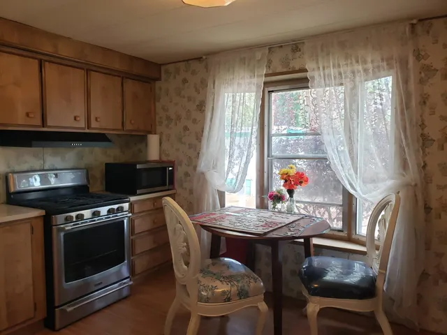 a view of a porch with a floor to ceiling window and wooden floor