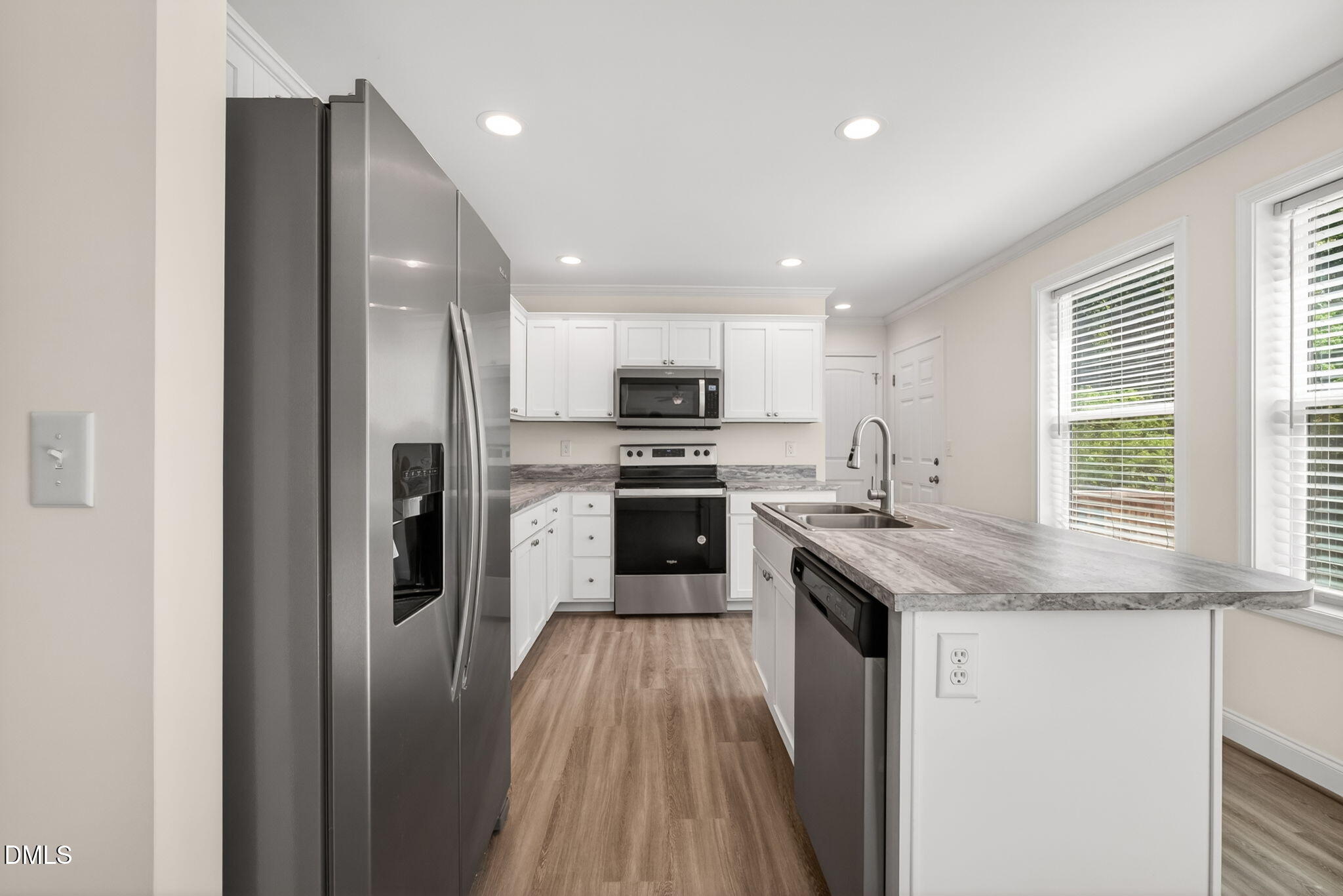 7122 Guess Road Hillsborough, NC 27278 - Photo 9 of 48 a kitchen with a sink a counter top space stainless steel appliances and a window