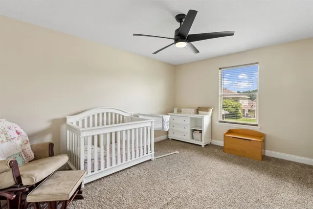 a bathroom with a granite countertop toilet sink and mirror