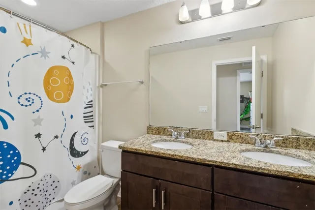 a bedroom with furniture and a flat screen tv