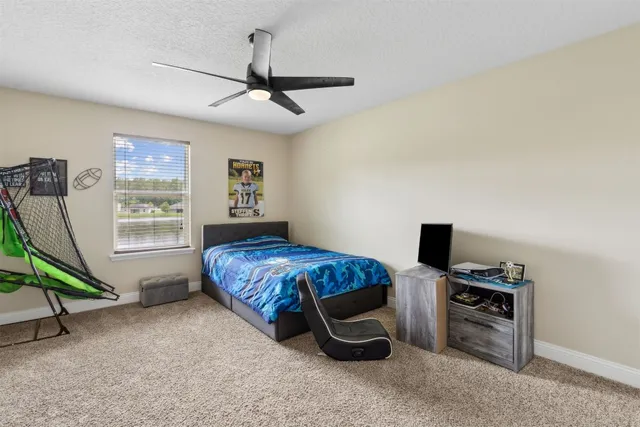 a bedroom with bed and a window