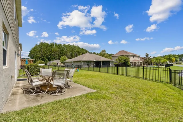 a view of a house with backyard porch and sitting area