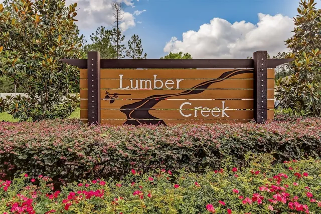 a living room with patio furniture and a large window