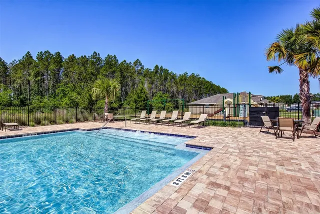 a view of a house with swimming pool and a yard