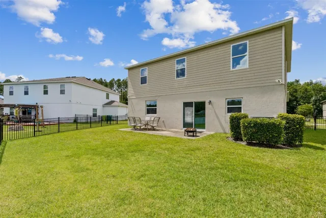 a view of dining room with furniture and a flat screen tv