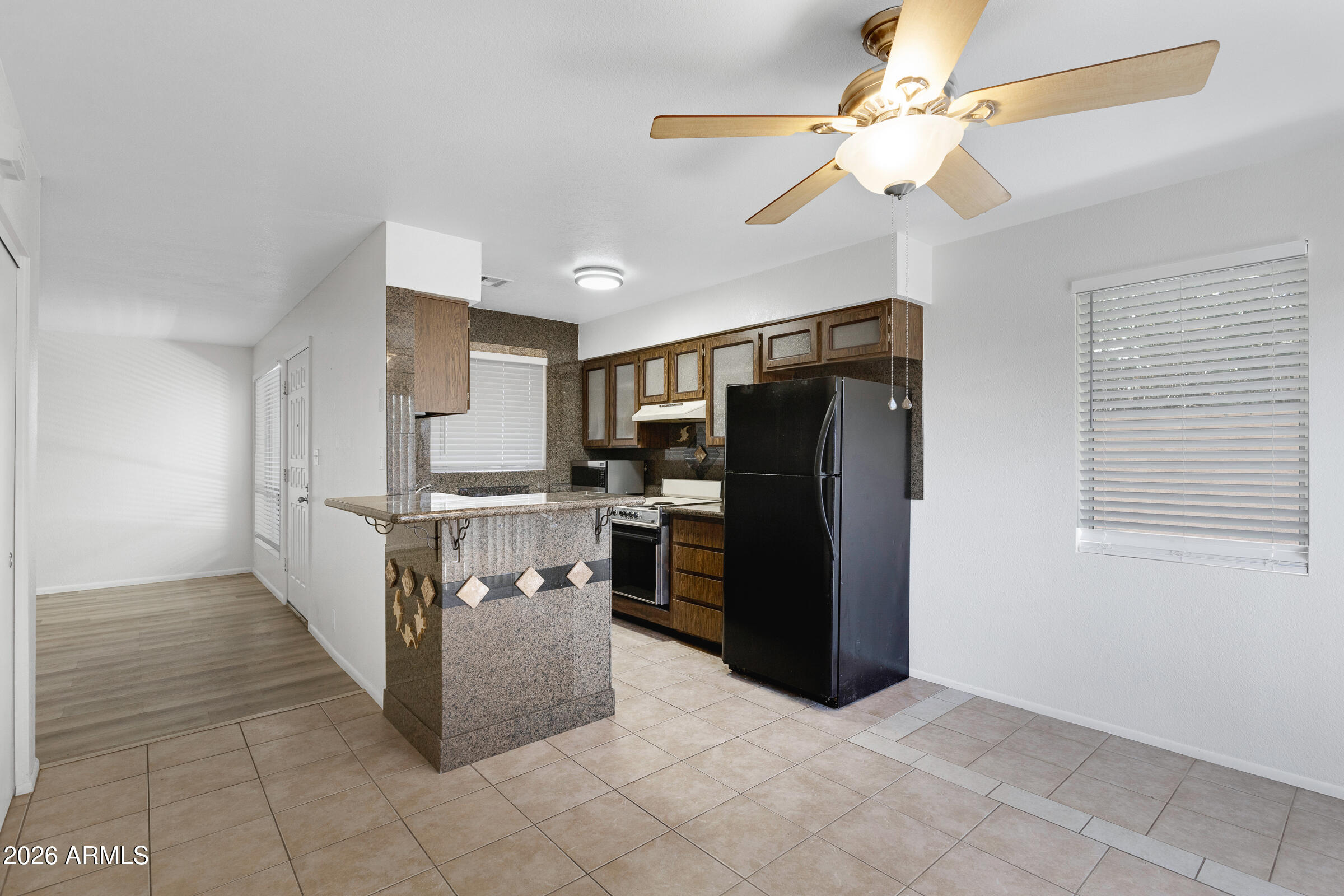 20235 North 3rd Drive, Unit 8 Phoenix, AZ 85027 - Photo 16 of 30 a view of kitchen with refrigerator cabinets and ceiling fan