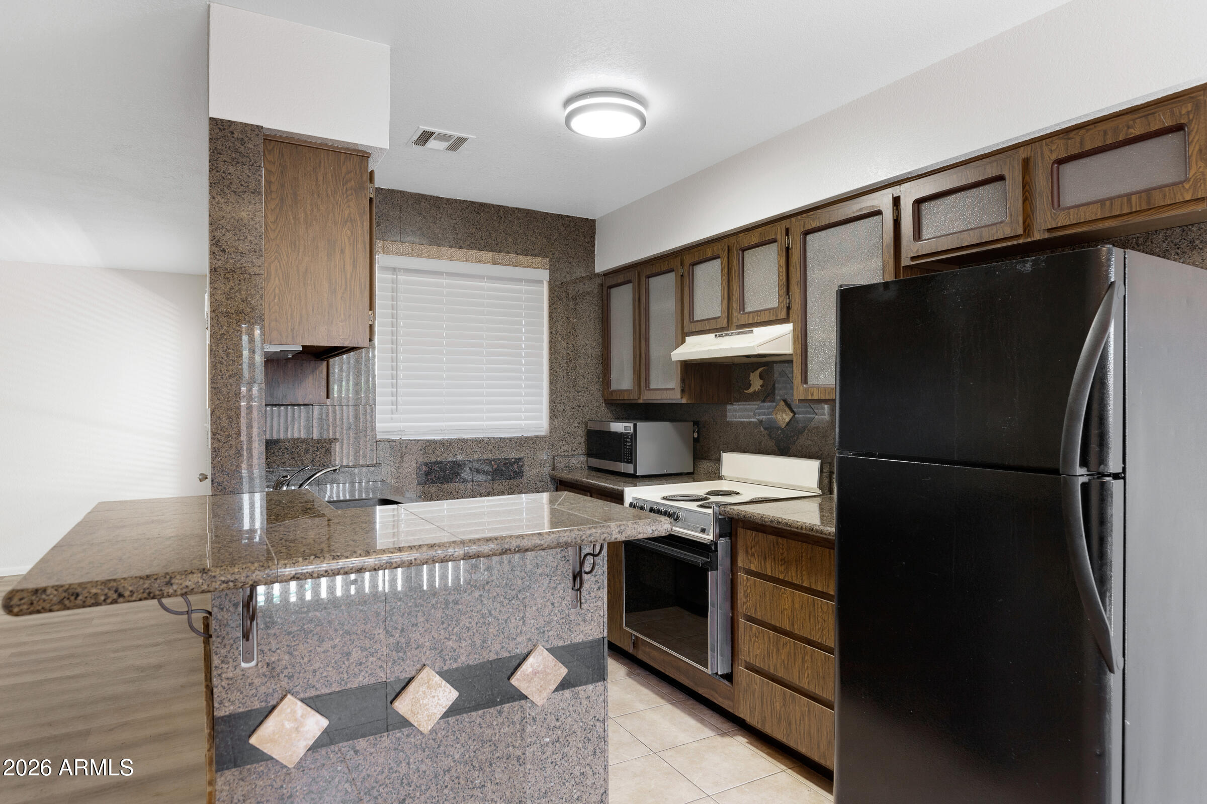 20235 North 3rd Drive, Unit 8 Phoenix, AZ 85027 - Photo 18 of 30 a kitchen with a refrigerator and a sink