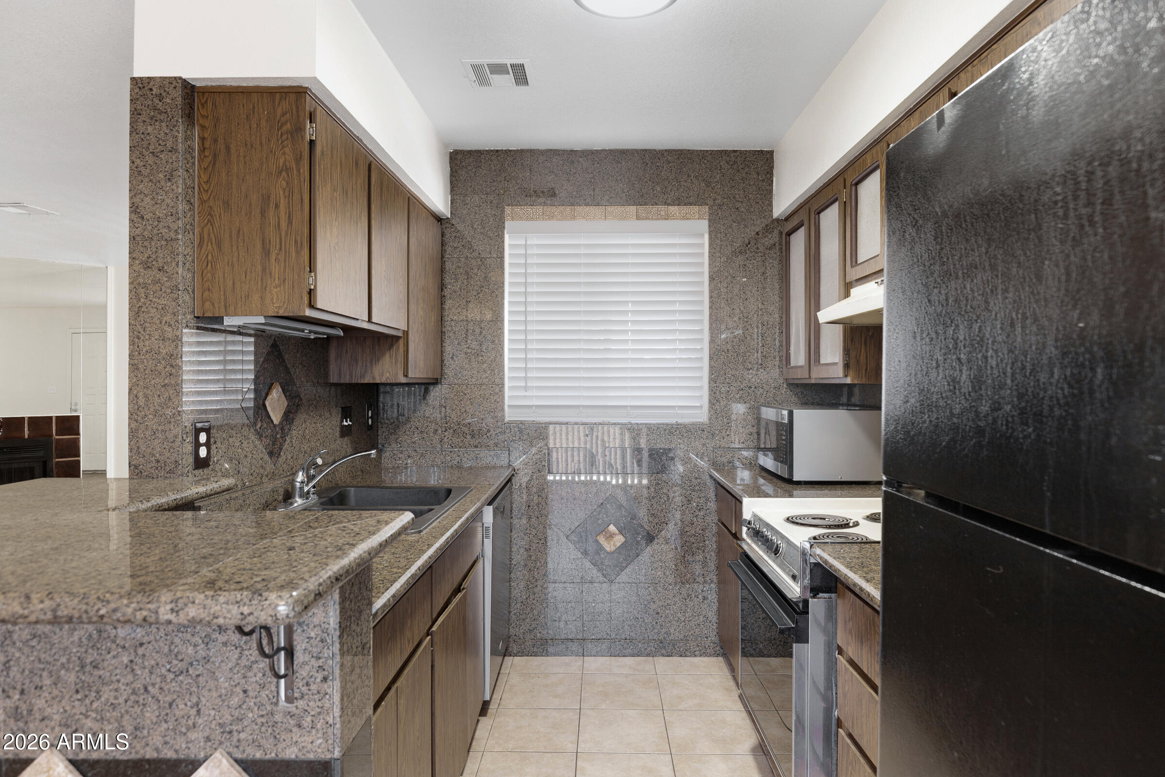 20235 North 3rd Drive, Unit 8 Phoenix, AZ 85027 - Photo 19 of 30 a kitchen with a sink stove and cabinets