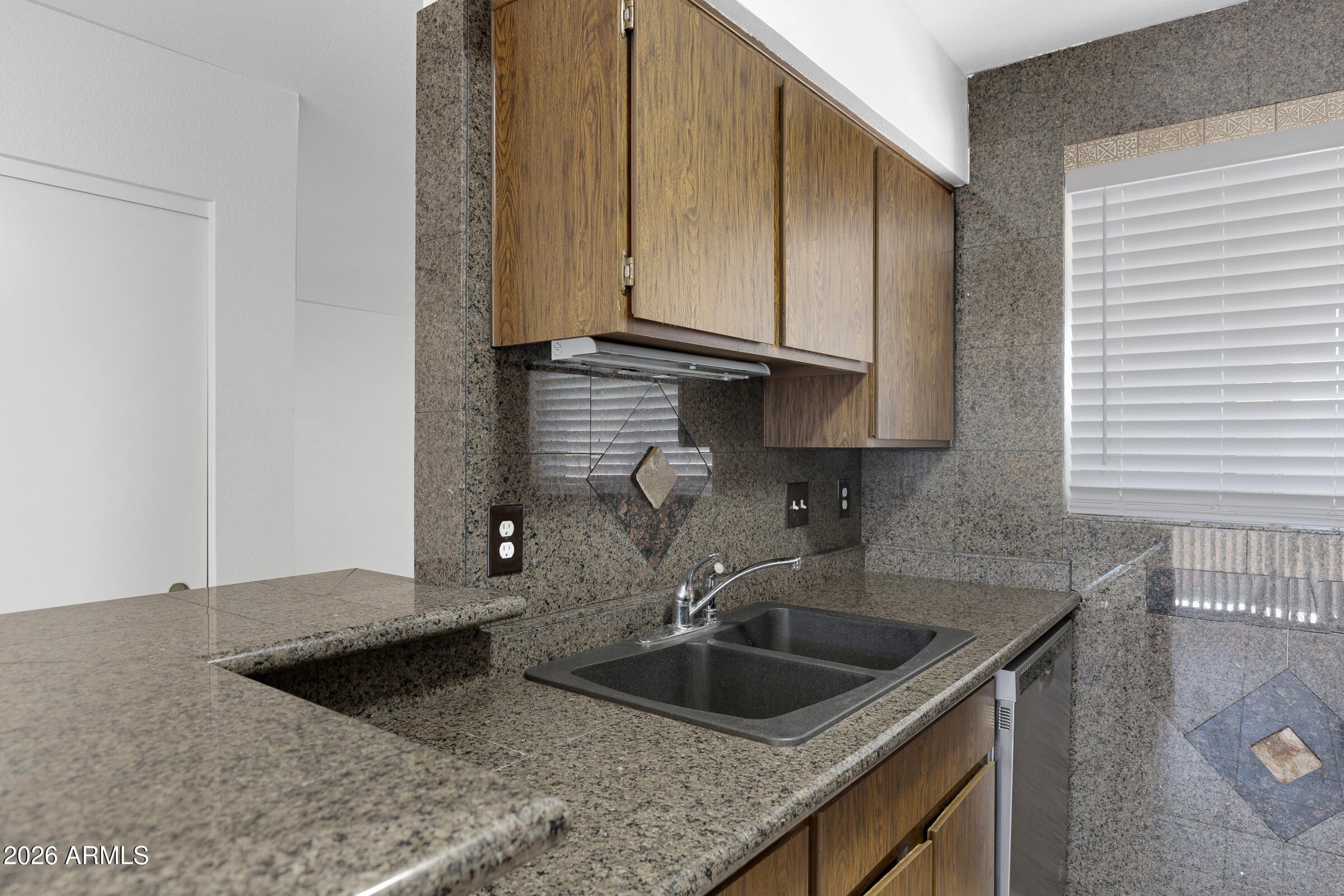 20235 North 3rd Drive, Unit 8 Phoenix, AZ 85027 - Photo 20 of 30 a kitchen with stainless steel appliances granite countertop a sink and a refrigerator