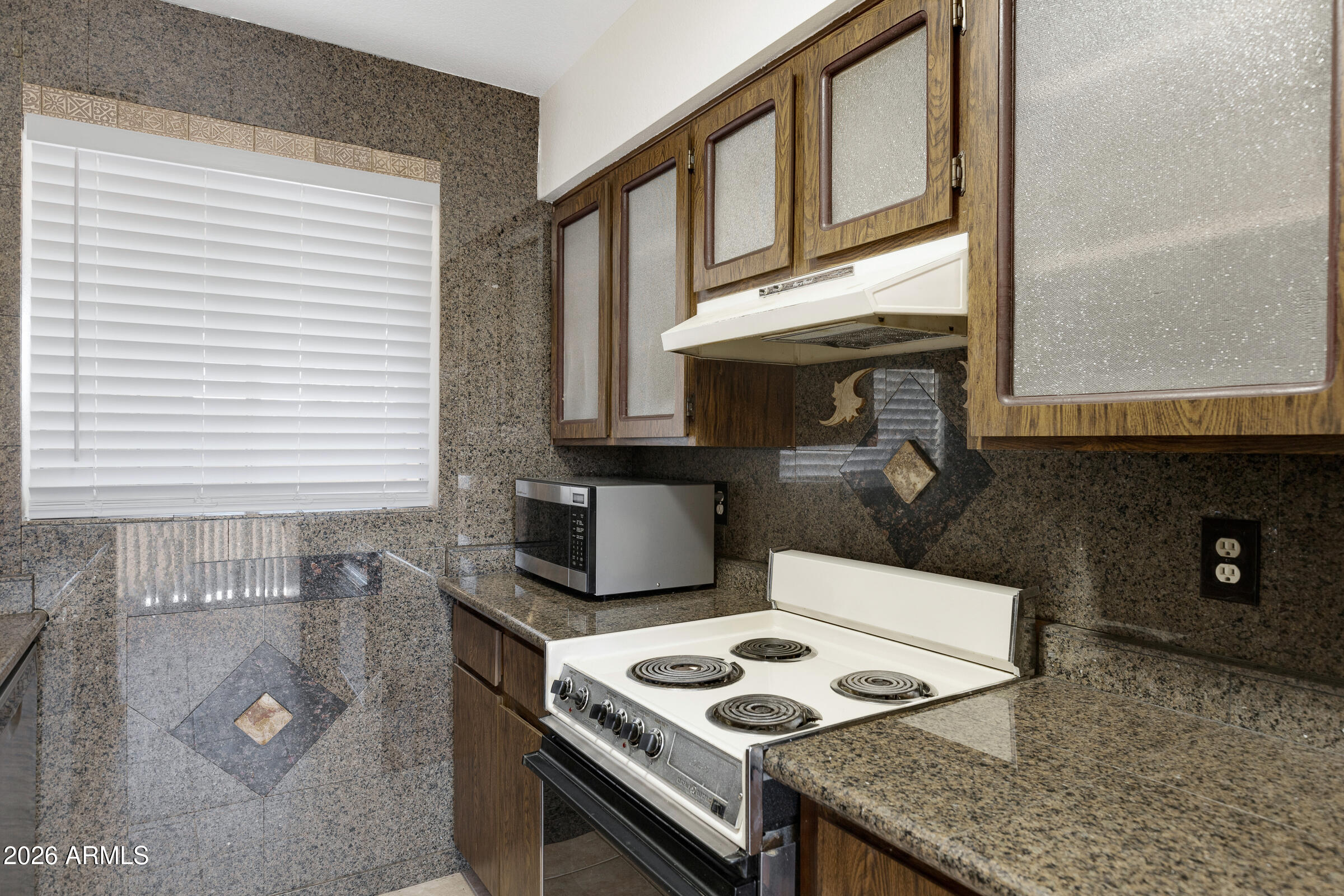 20235 North 3rd Drive, Unit 8 Phoenix, AZ 85027 - Photo 21 of 30 a kitchen with granite countertop a sink stove and cabinets