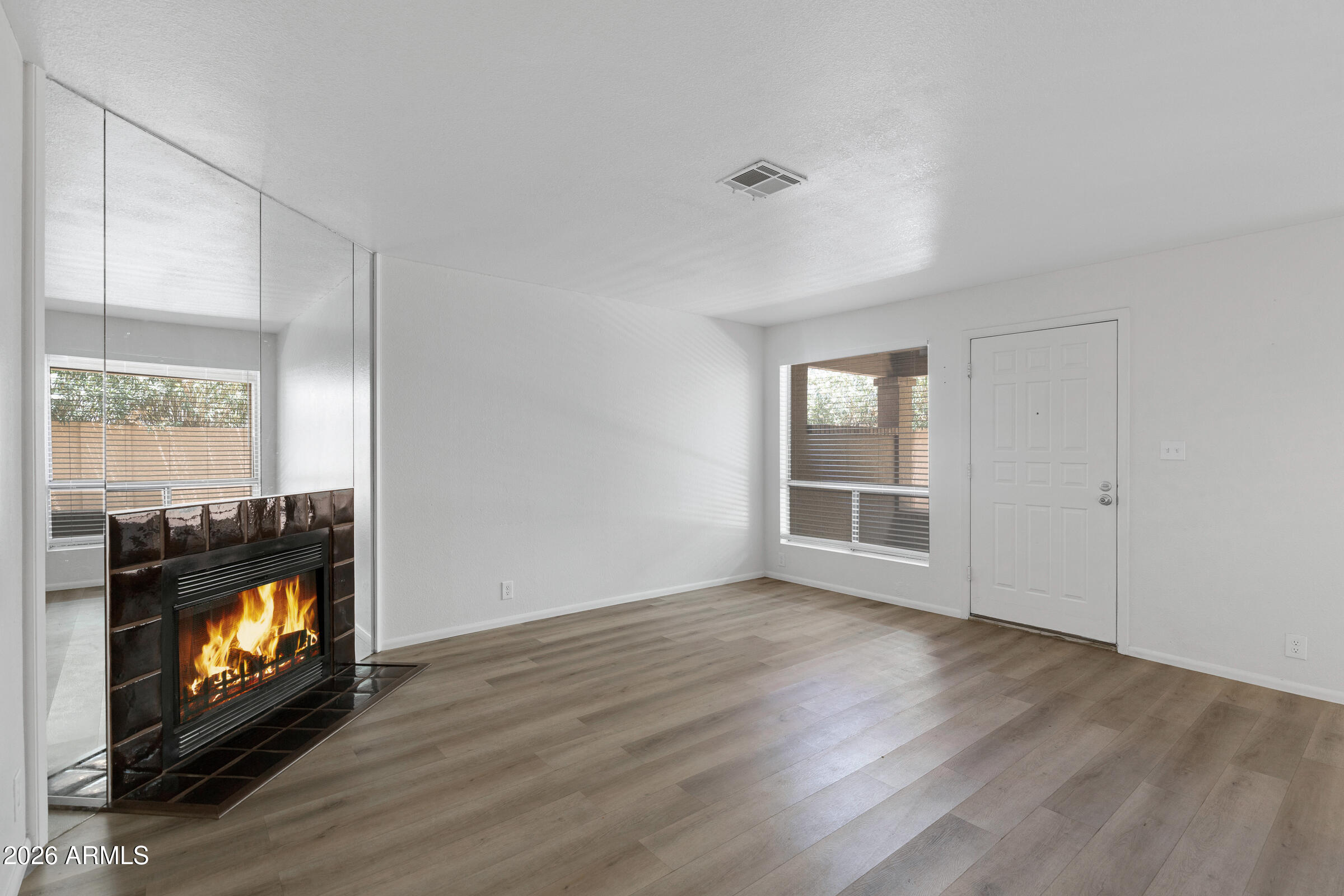 20235 North 3rd Drive, Unit 8 Phoenix, AZ 85027 - Photo 3 of 30 a view of an empty room with a fireplace and a window
