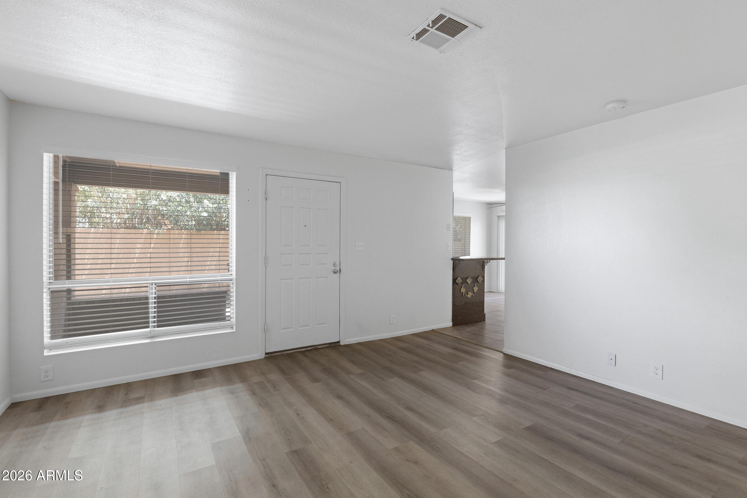 20235 North 3rd Drive, Unit 8 Phoenix, AZ 85027 - Photo 5 of 30 a view of empty room with wooden floor and fan