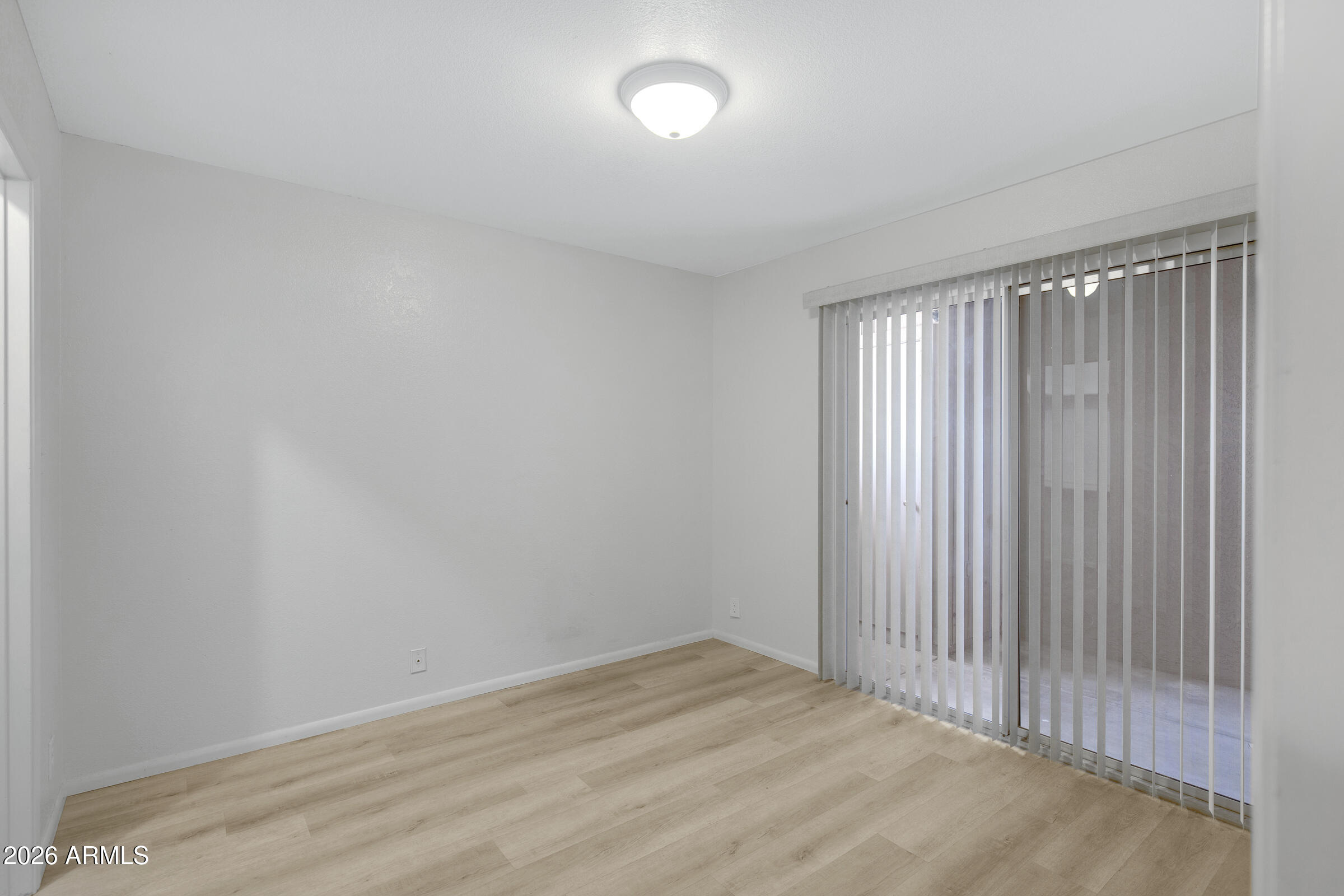 20235 North 3rd Drive, Unit 8 Phoenix, AZ 85027 - Photo 8 of 30 a view of an empty room with wooden floor