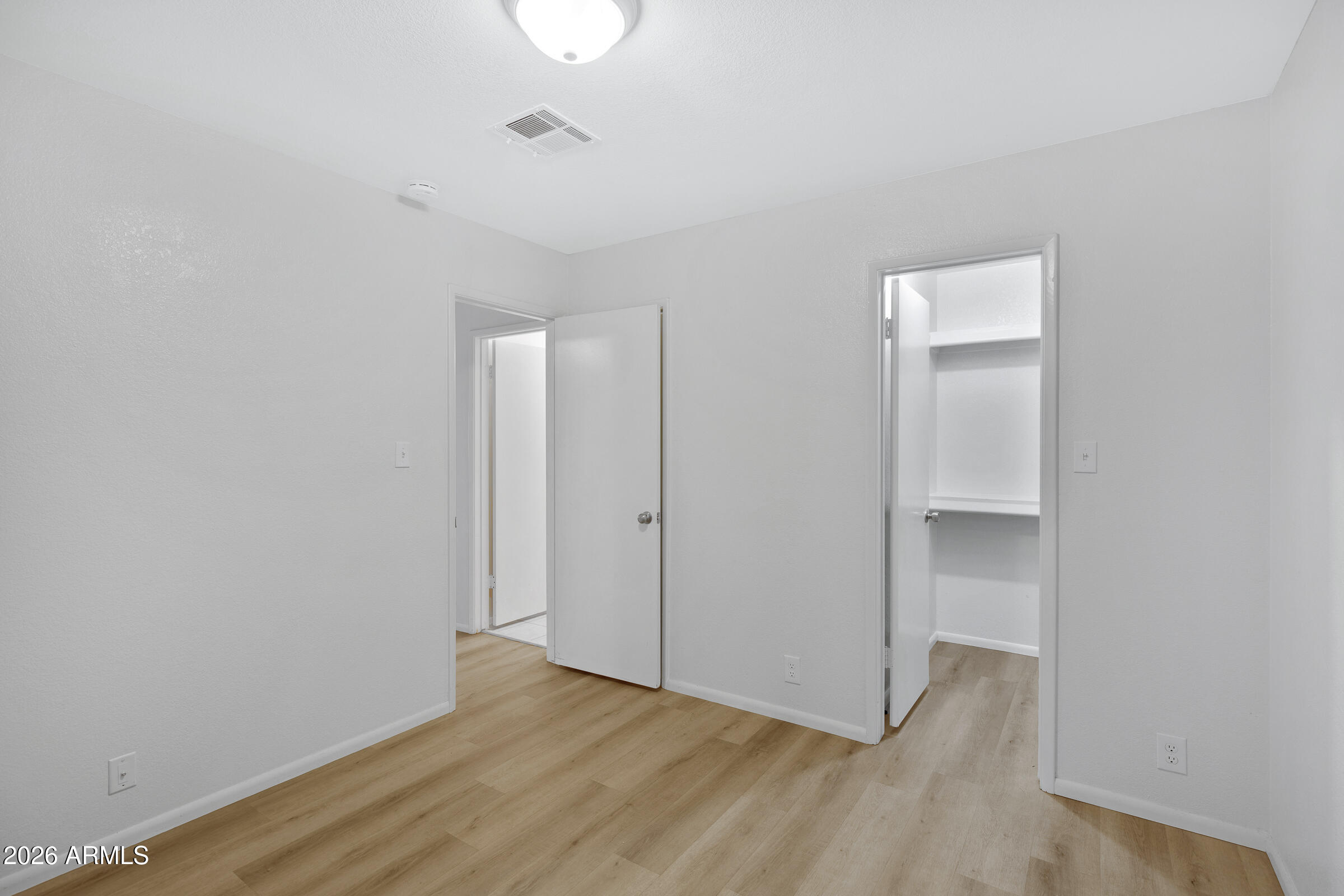 20235 North 3rd Drive, Unit 8 Phoenix, AZ 85027 - Photo 9 of 30 a view of an empty room with wooden floor