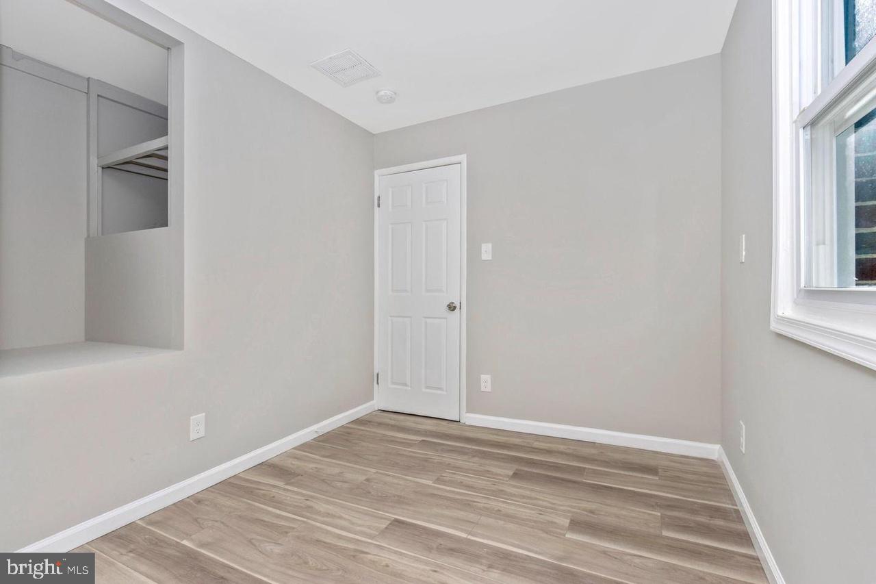6738 Allview Drive Columbia, MD 21046 - Photo 16 of 33 a view of empty room with wooden floor and fan